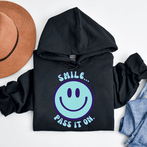 Introducing the ultimate mood booster in fabric form: the "Smile…Pass It On" Happy Face Hoodie! This isn't just any ordinary hoodie; it's a wearable ray of sunshine, guaranteed to spread joy, high-fives, and possibly even spontaneous dance-offs wherever you go.